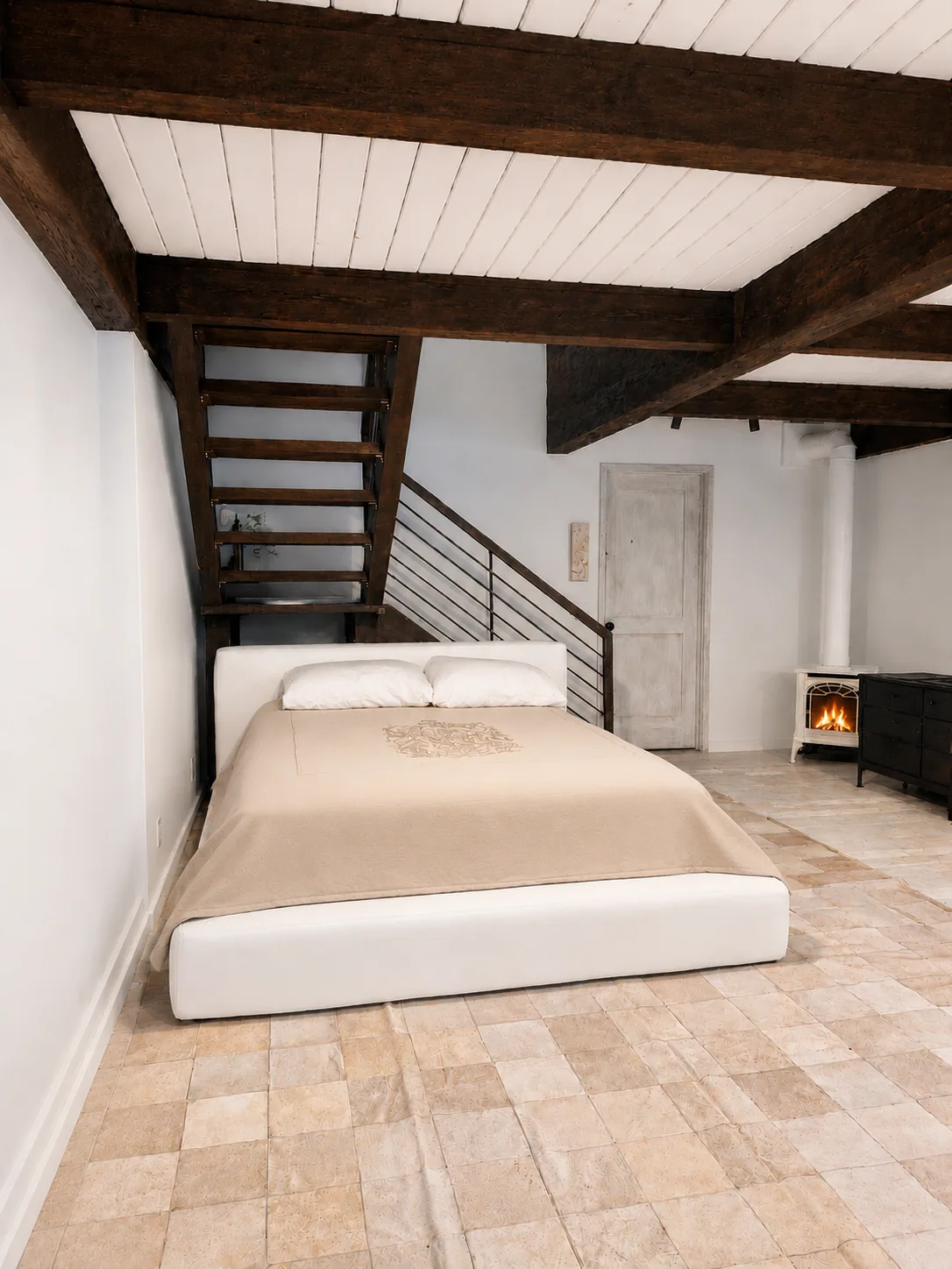 Loft bedroom with wood-burning stove