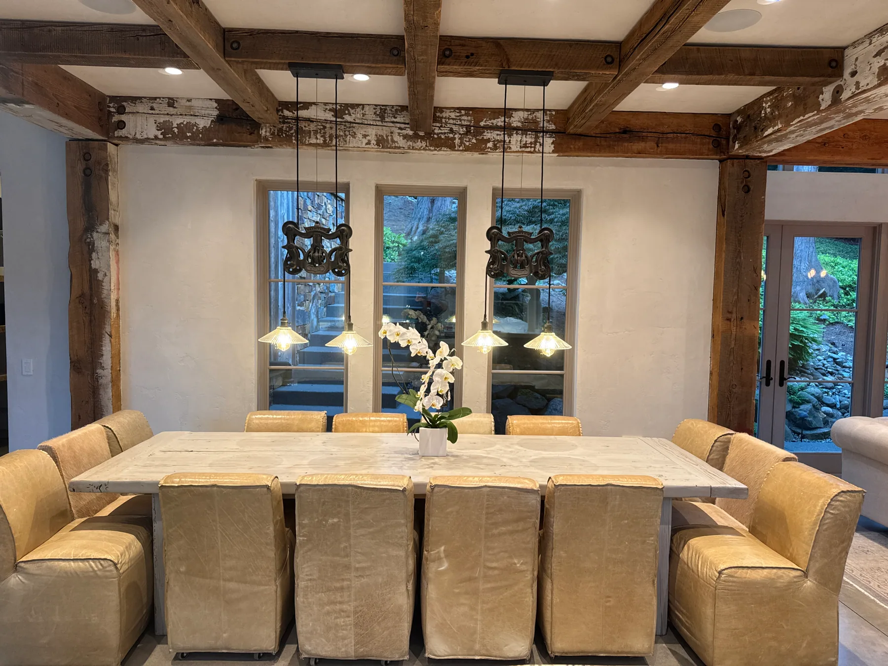 Dining room with leather chairs and pendant lights